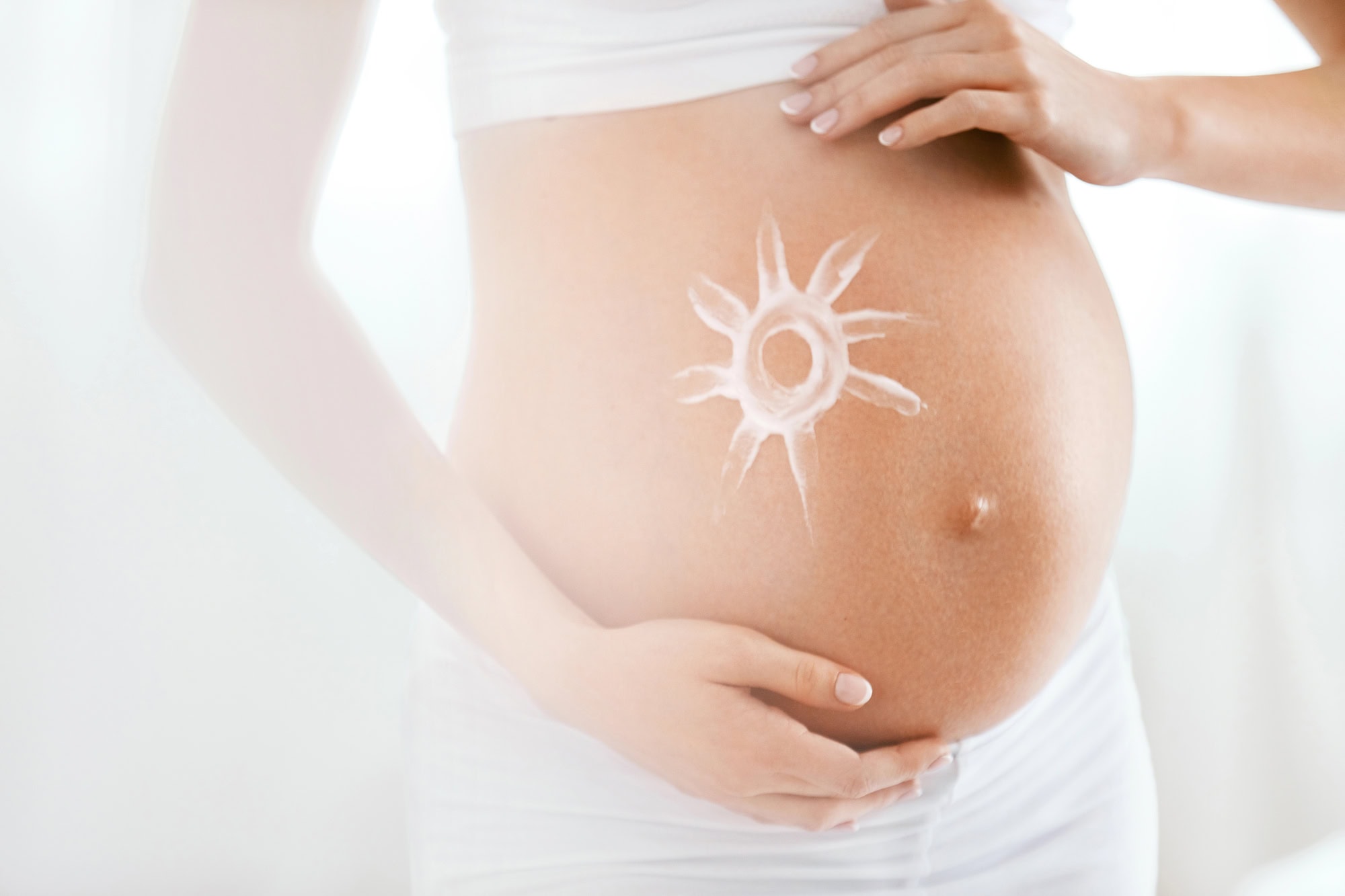 Baby Belly Skin Care. Pregnant Woman With Cream Sun On Skin Baby Belly Skin Care. Pregnant Woman With Cream Sun On Skin