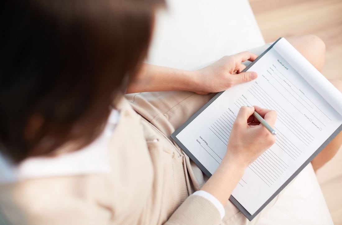 Woman writing a medical record